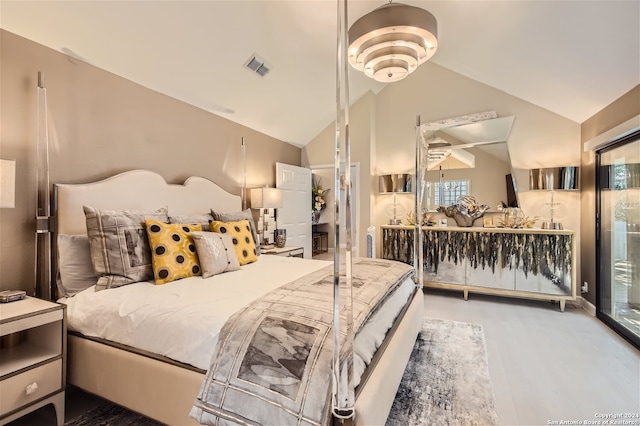 bedroom featuring hardwood / wood-style floors and lofted ceiling