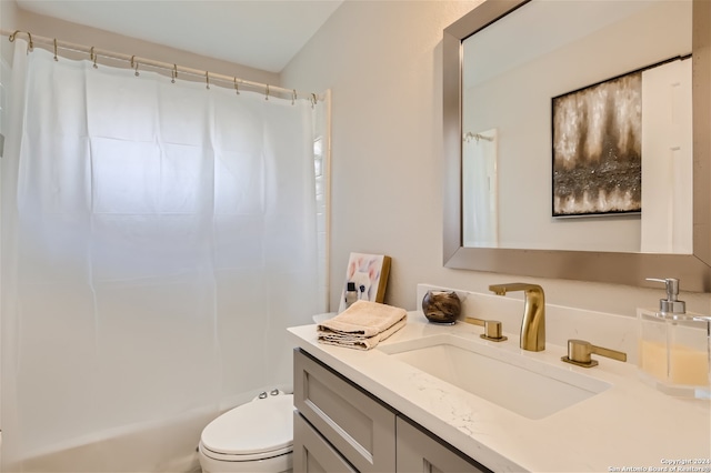 bathroom featuring vanity, curtained shower, and toilet