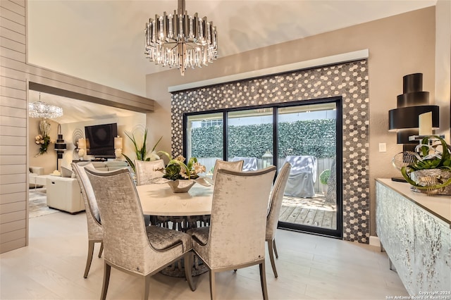 dining room with a notable chandelier and light hardwood / wood-style flooring