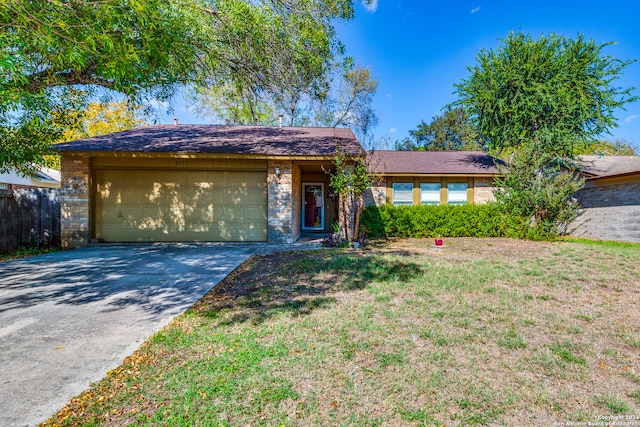 single story home with a garage and a front lawn