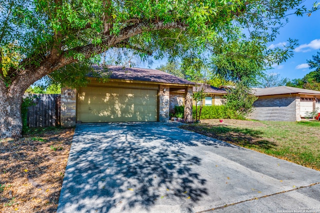 view of front of property with a garage and a front lawn