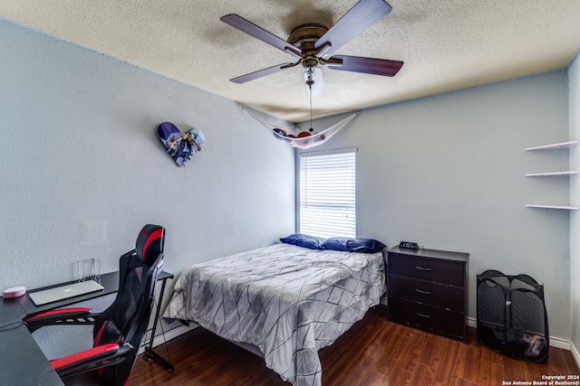 bedroom featuring a textured ceiling, dark hardwood / wood-style flooring, and ceiling fan