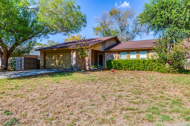 ranch-style home featuring a front yard and a garage