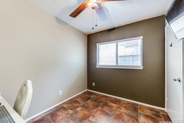 interior space featuring a textured ceiling and ceiling fan