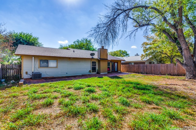 rear view of house with a yard and a patio