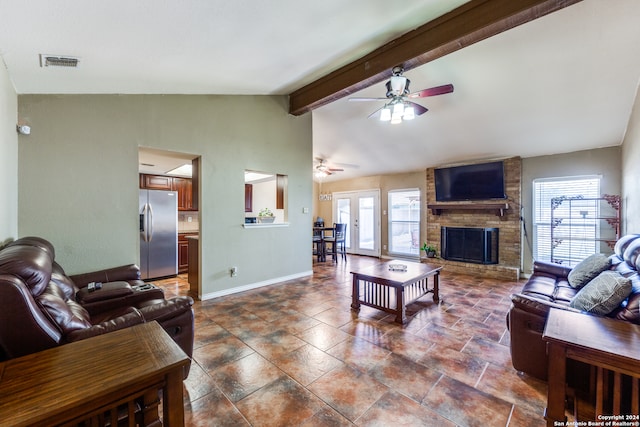 living room with lofted ceiling with beams, ceiling fan, and a fireplace