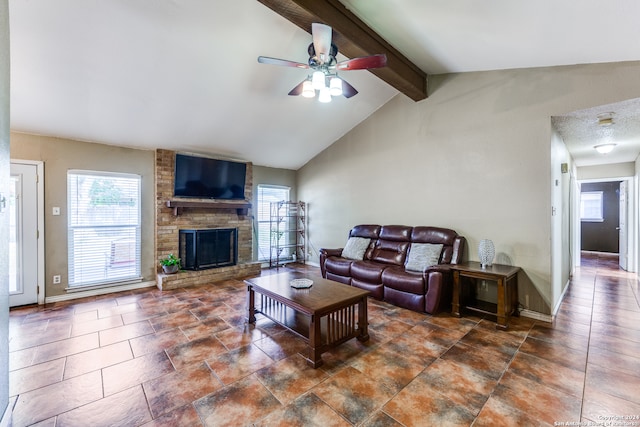 living room with lofted ceiling with beams, ceiling fan, and a fireplace