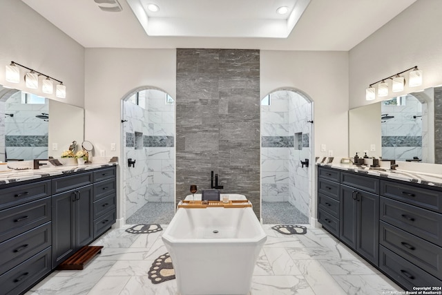 bathroom featuring vanity, tile walls, and shower with separate bathtub