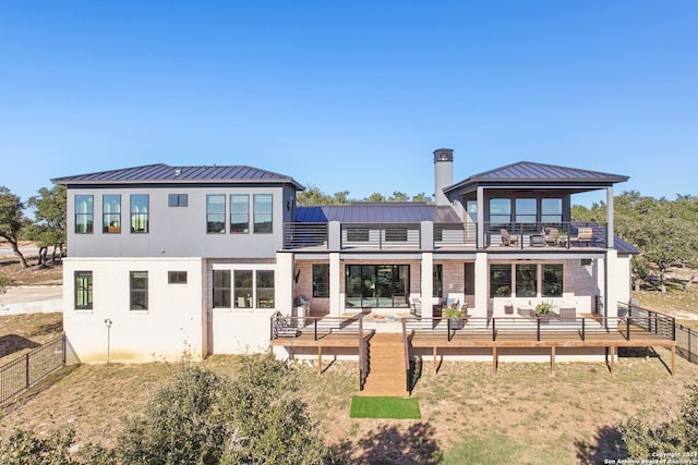 back of house with a balcony and an outdoor hangout area