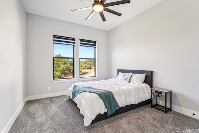 bedroom with dark colored carpet and ceiling fan