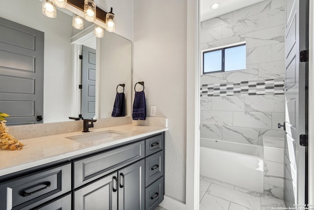 bathroom featuring vanity and tiled shower / bath