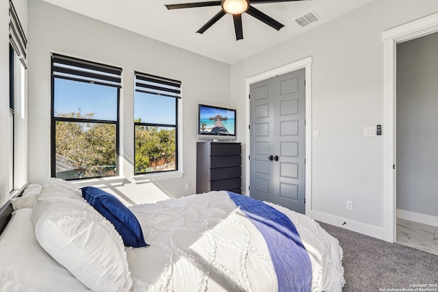 bedroom with ceiling fan, a closet, and carpet