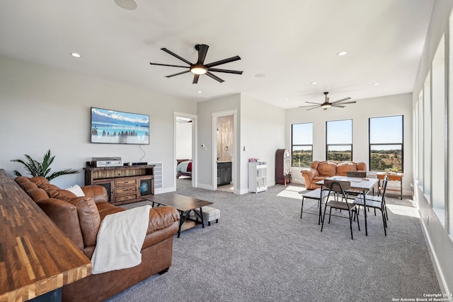 carpeted living room featuring ceiling fan