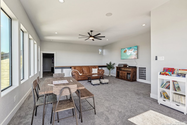 living room featuring carpet flooring, ceiling fan, and a healthy amount of sunlight