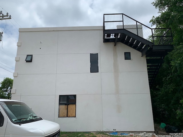 view of side of property with a balcony