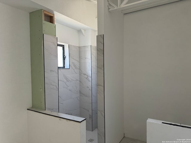 bathroom with a tile shower