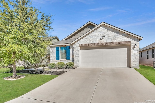 view of front of house featuring a front yard and a garage