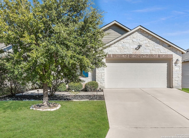 obstructed view of property featuring a front yard and a garage