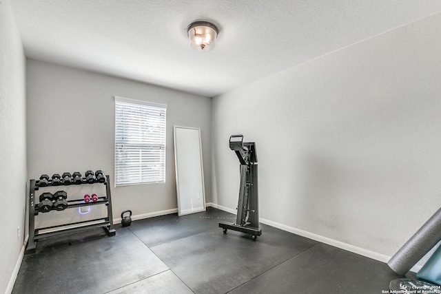 exercise room featuring a textured ceiling