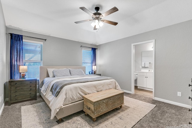 carpeted bedroom featuring ensuite bathroom and ceiling fan