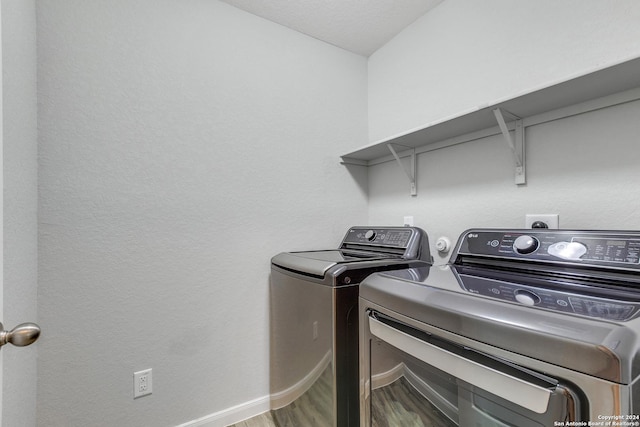 washroom featuring washer and dryer and hardwood / wood-style floors