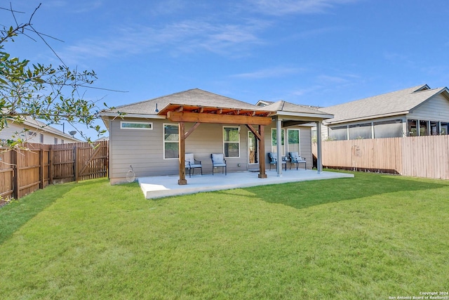 rear view of house featuring a yard, a patio, and a pergola