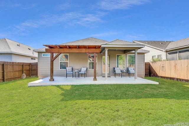 back of property featuring a yard and a patio