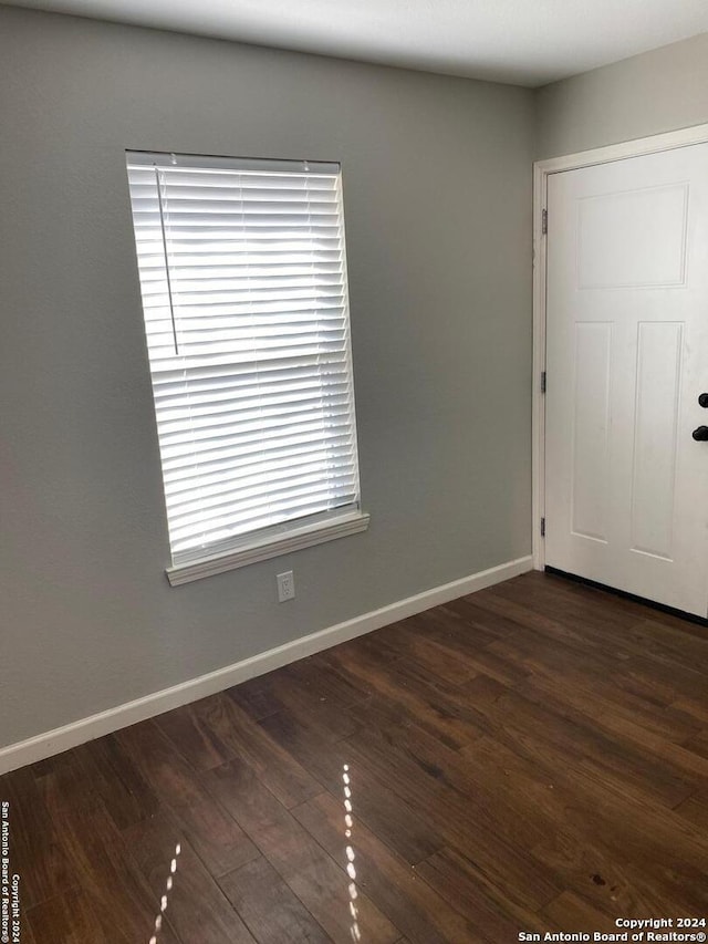 unfurnished room with dark hardwood / wood-style floors