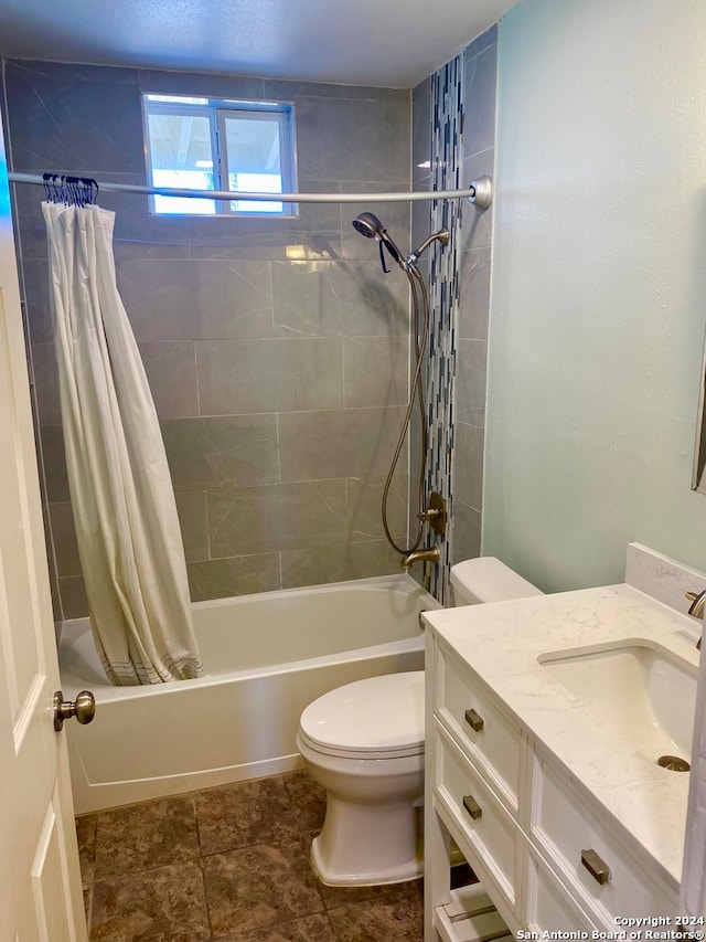 full bathroom featuring tile patterned floors, shower / tub combo with curtain, vanity, and toilet