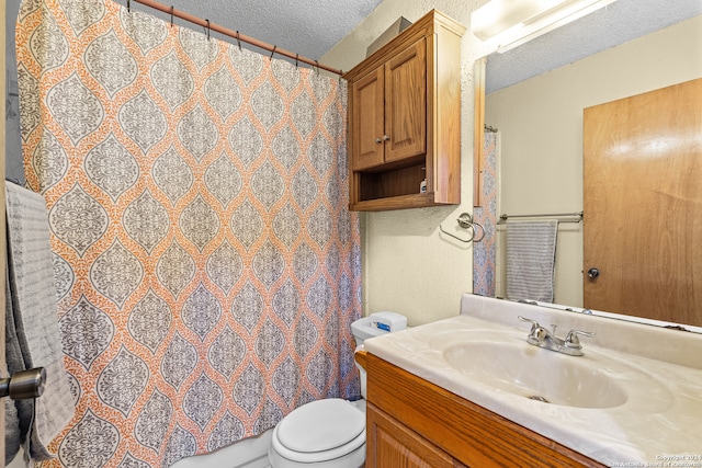 bathroom featuring vanity, a textured ceiling, toilet, and a shower with shower curtain