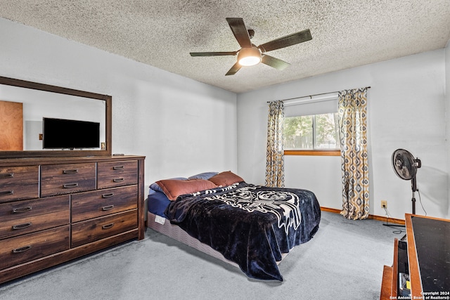 carpeted bedroom with a textured ceiling and ceiling fan