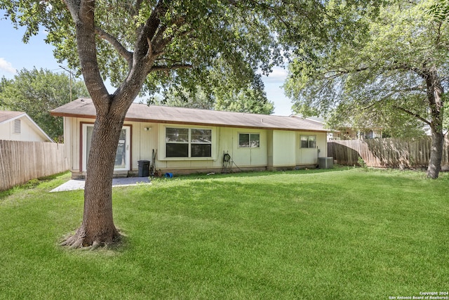 exterior space featuring central AC unit and a front yard