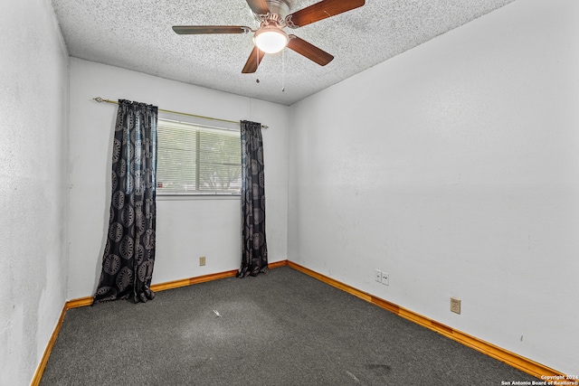 carpeted spare room featuring a textured ceiling and ceiling fan