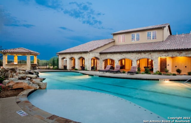 view of swimming pool with a gazebo and a patio