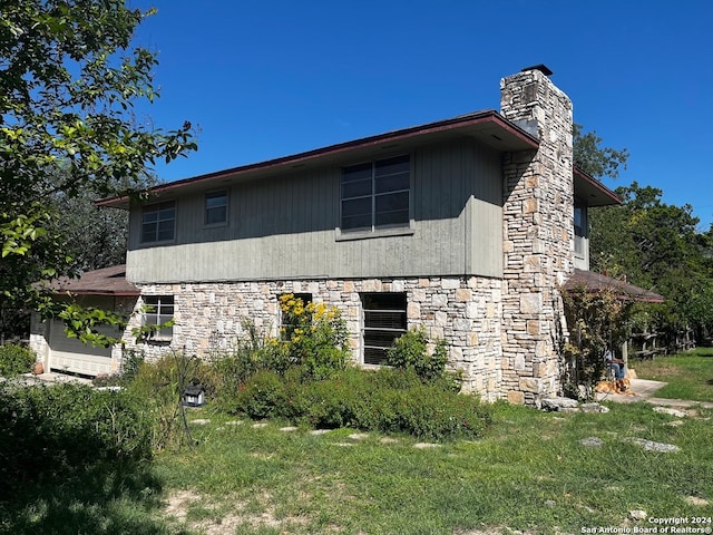 view of home's exterior with a lawn