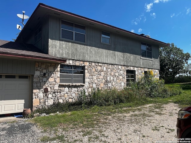 view of side of home with a garage