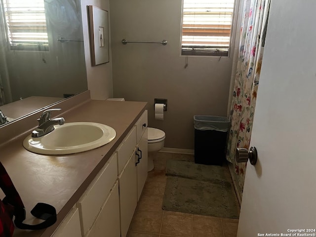 bathroom featuring tile patterned flooring, vanity, and toilet