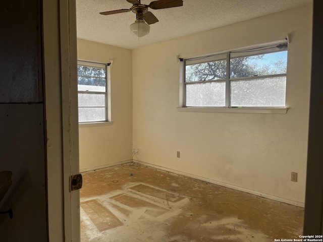 spare room with ceiling fan and a textured ceiling