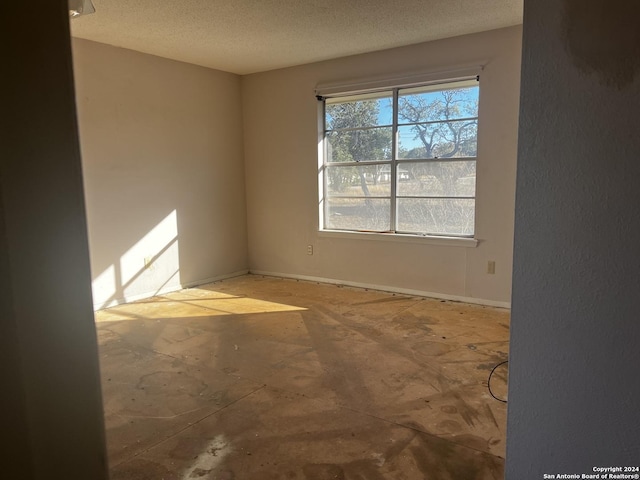 spare room with a textured ceiling