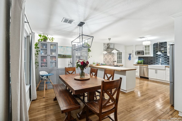 dining room with visible vents and light wood-style flooring