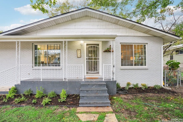 bungalow-style home with brick siding and covered porch