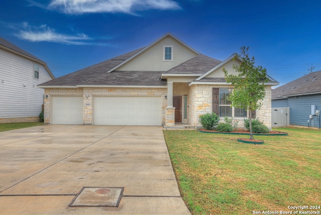 view of front of house with a garage and a front yard