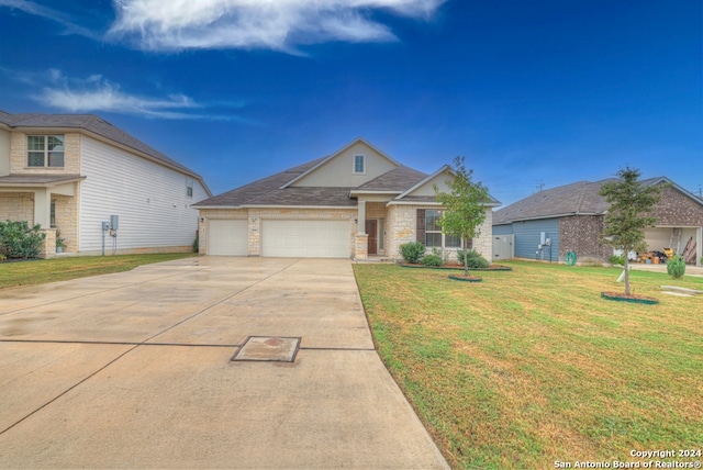 view of front of home featuring a garage and a front yard