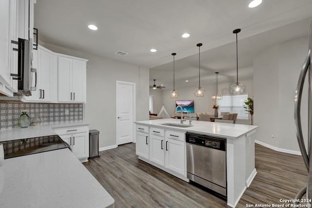 kitchen featuring appliances with stainless steel finishes, a kitchen island with sink, sink, dark hardwood / wood-style floors, and white cabinetry