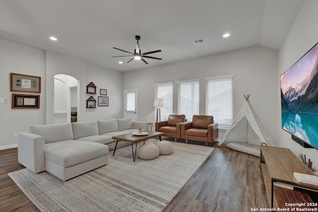 living room featuring wood-type flooring, ceiling fan, and lofted ceiling