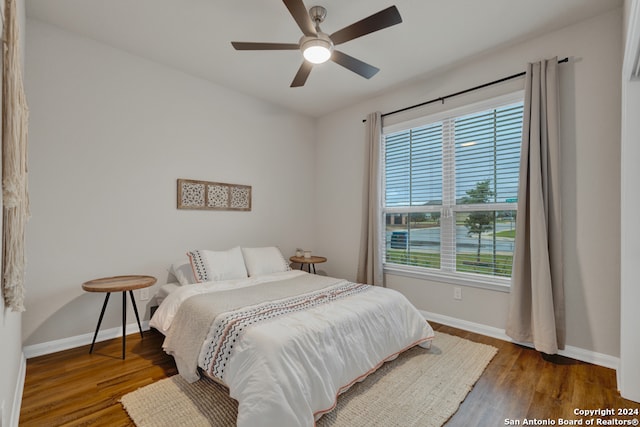 bedroom with ceiling fan and dark wood-type flooring