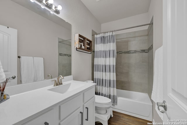 full bathroom featuring vanity, hardwood / wood-style floors, shower / bathtub combination with curtain, and toilet