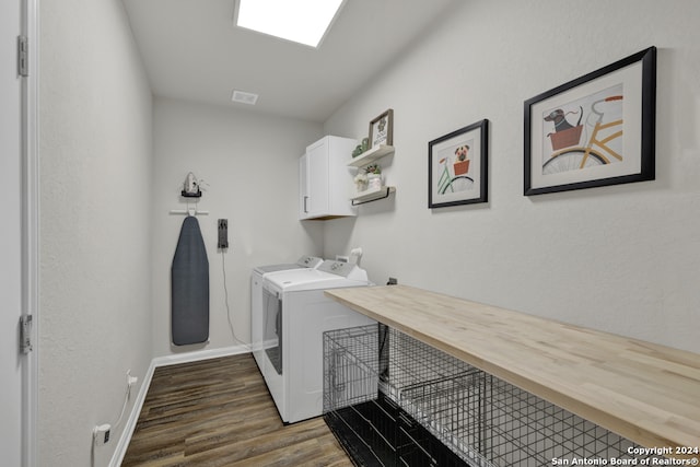 laundry area with separate washer and dryer, cabinets, and dark wood-type flooring