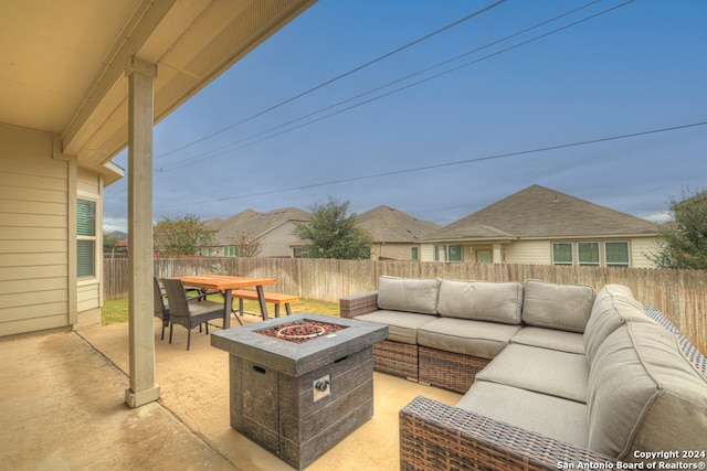 view of patio featuring an outdoor living space with a fire pit