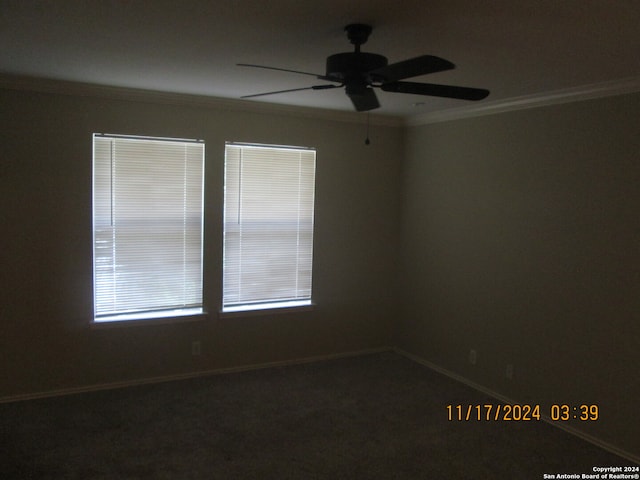 carpeted empty room featuring ceiling fan and crown molding